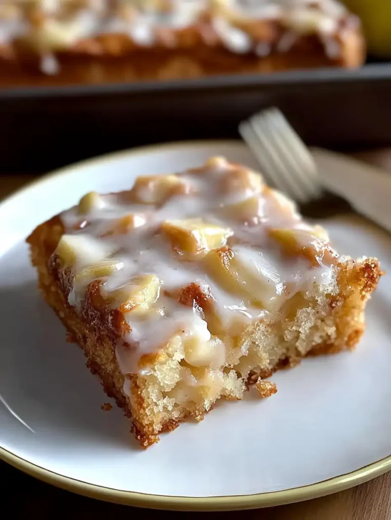 A white plate topped with a piece of Apple Fritter Cake