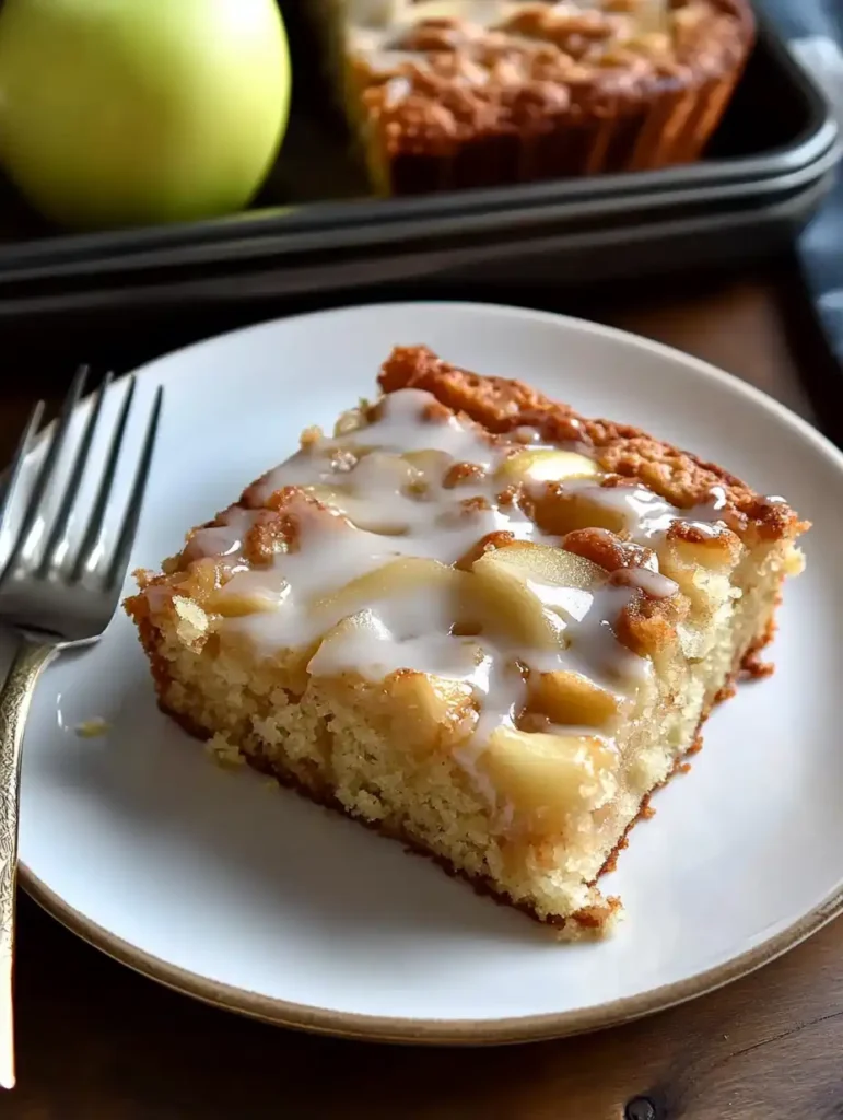 A piece of Apple Fritter Cake on a plate with a fork
